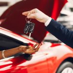 Woman buying the car. Lady in a car salon. Manager with a clients
